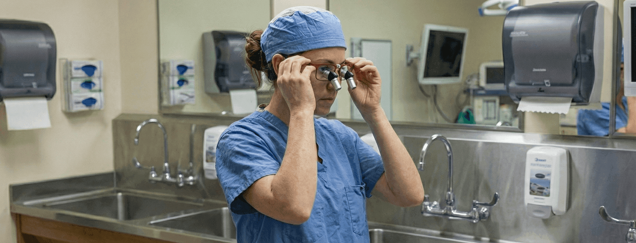 Clinician preparing with HeliosX loupes before a procedure